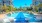 Large sparkling blue pool with a large pool deck and lounge chairs